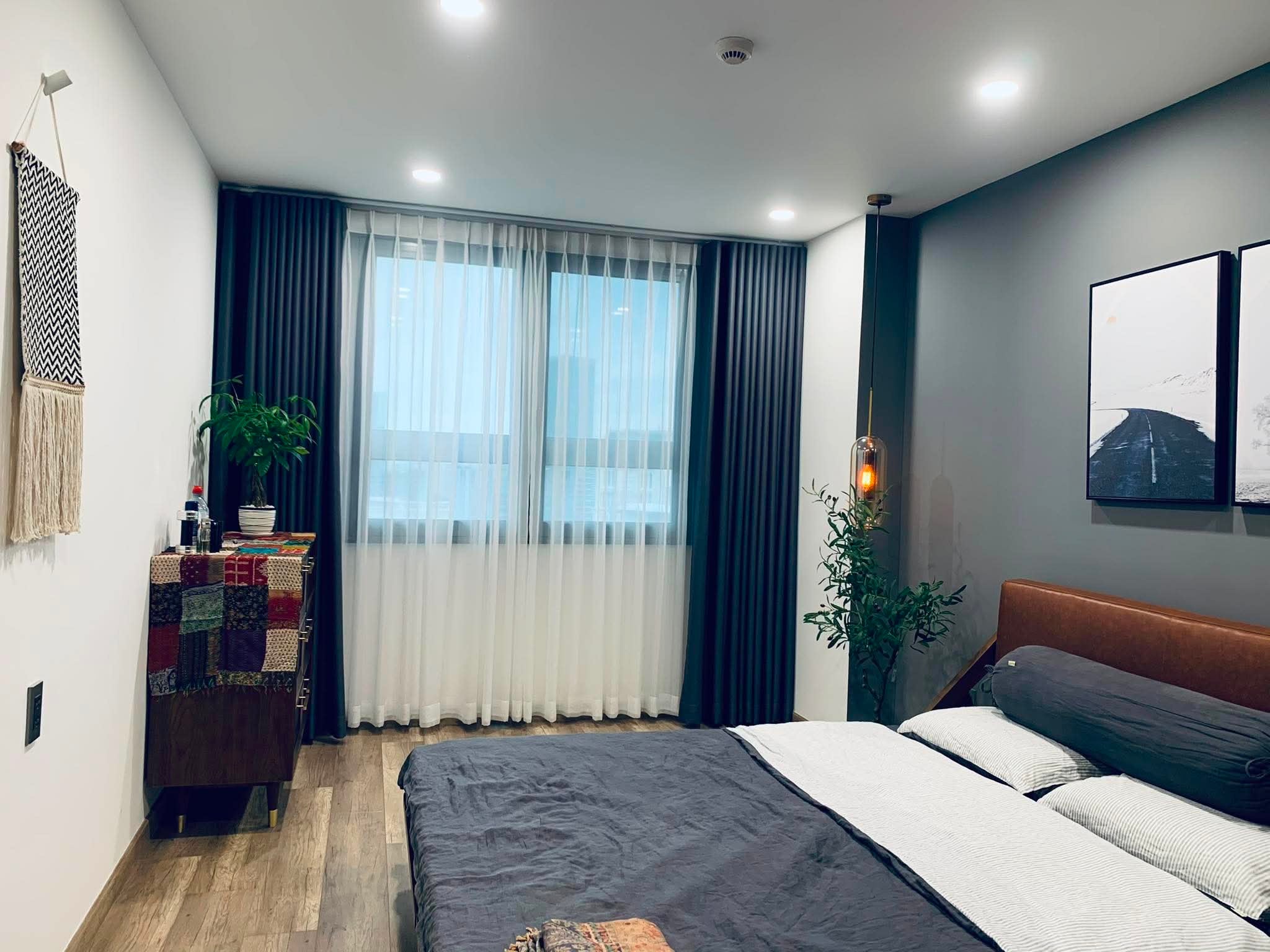 Real home grey bedroom with linen bedding in Scandinavian minimalist style