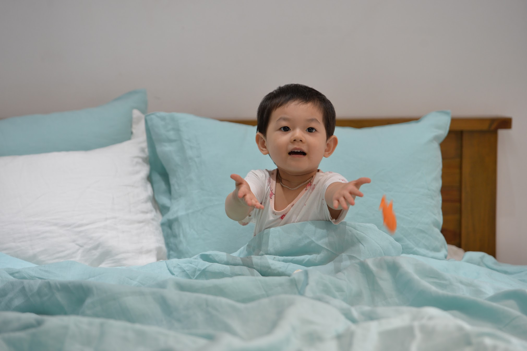 Baby sitting on soft stonewashed French linen sheets in light blue — SCANDALINEN