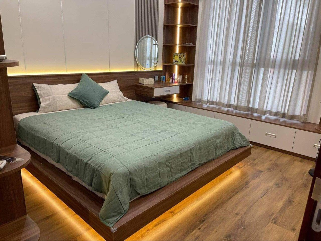 Sage green SCANDALINEN French linen bedding in a modern Vietnamese bedroom with LED underlighting
