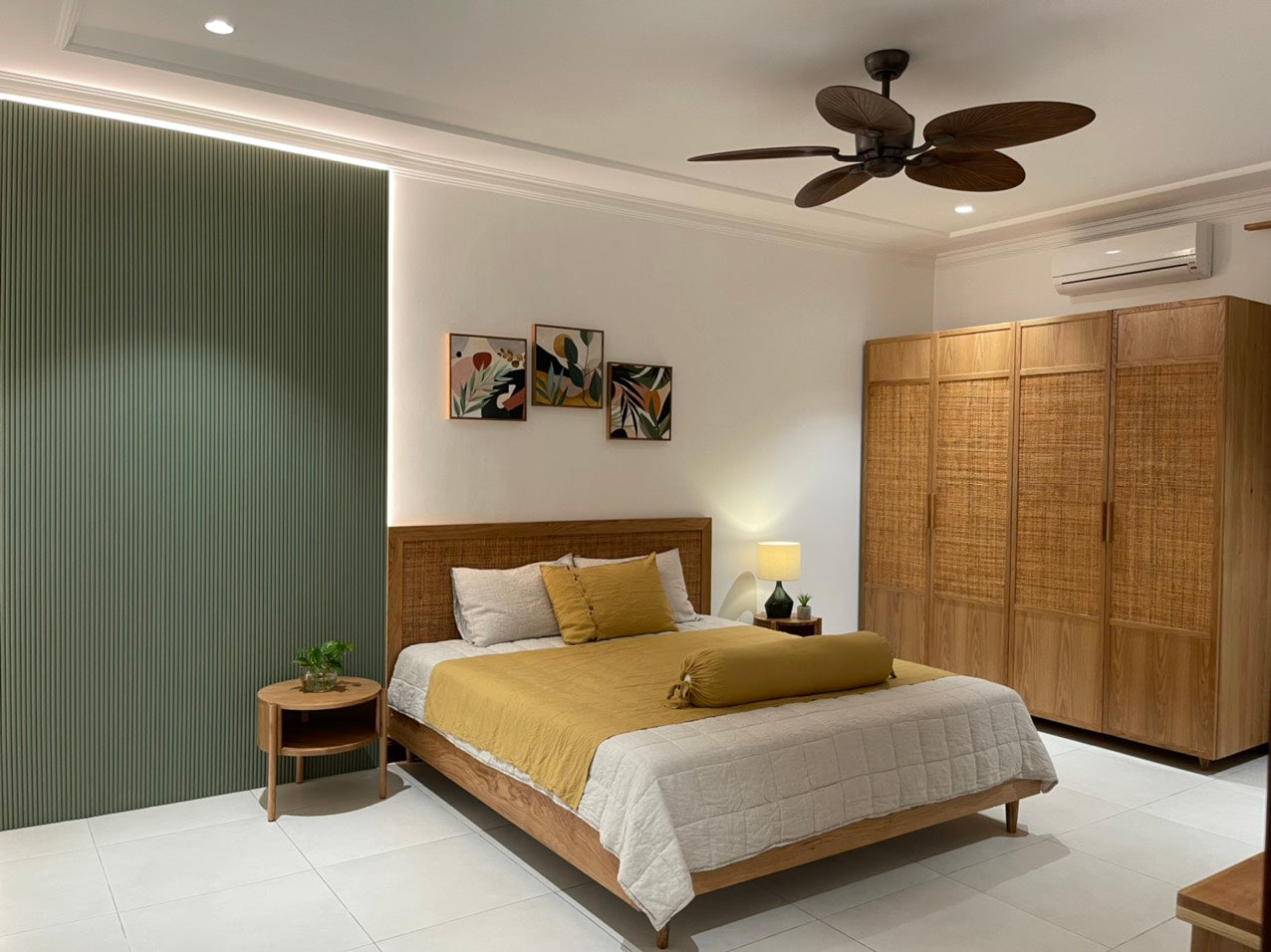 Mustard SCANDALINEN French linen bedding in a tropical bedroom with rattan furniture and ceiling fan