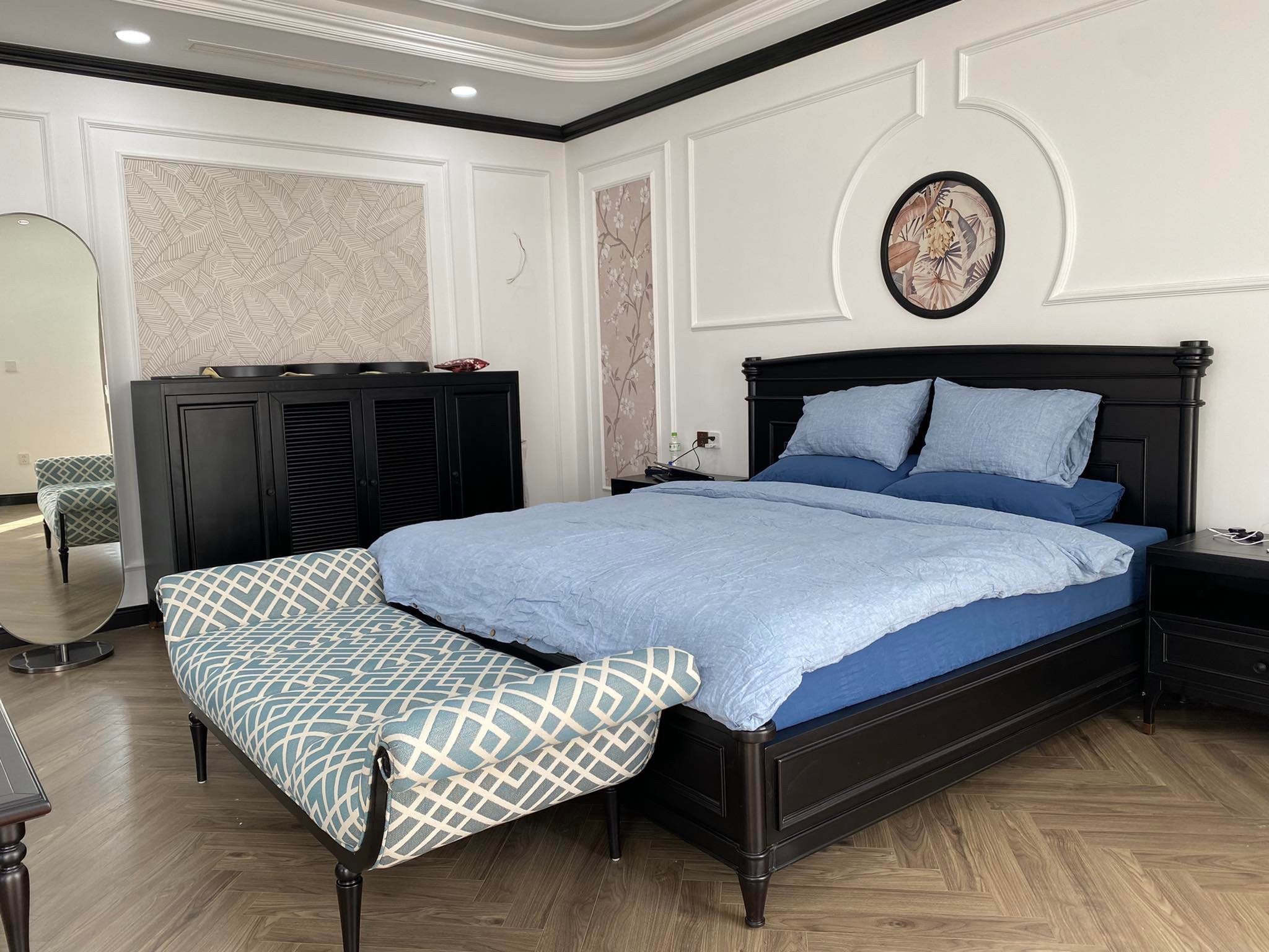 Baby blue SCANDALINEN French linen bedding on a black timber bed with herringbone floors