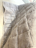 Mushroom taupe French linen quilted blanket on a bed, 100% European flax - SCANDALINEN