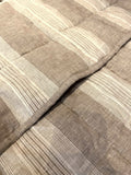 Natural oat stripe French linen quilted blanket on a bed, 100% European flax - SCANDALINEN