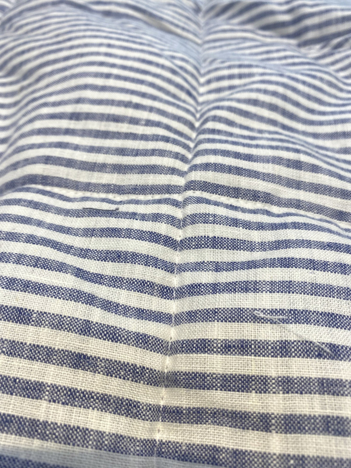 Navy pinstripe French linen quilted blanket on a bed, 100% European flax - SCANDALINEN