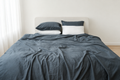 Grey bamboo linen duvet cover in a bright ivory bedroom, front view of the 70% bamboo rayon and 30% linen fabric
