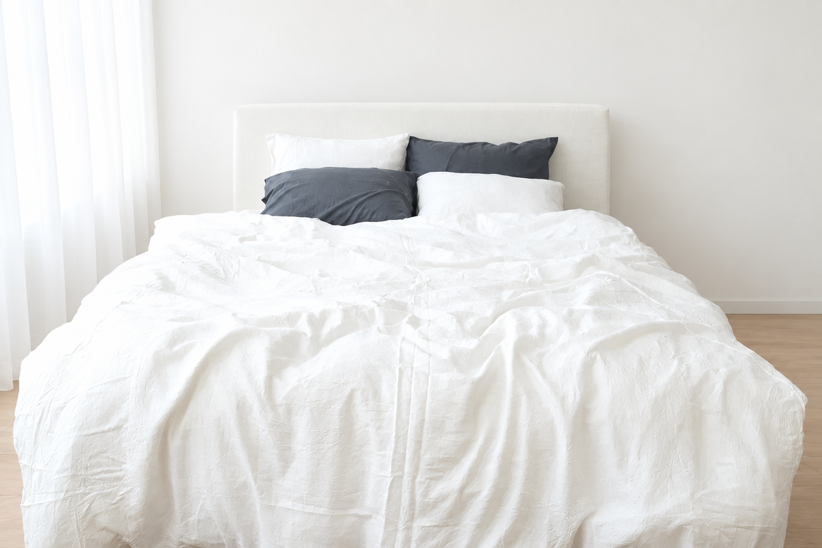 White bamboo linen duvet cover on a bed in a bright ivory room, front view